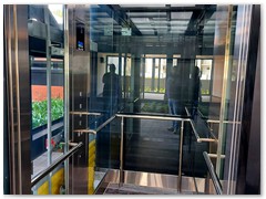 Glass passenger stretcher lift